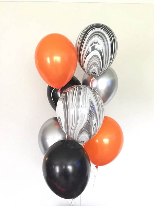Bouquet of balloons in orange, black, and silver on a white background