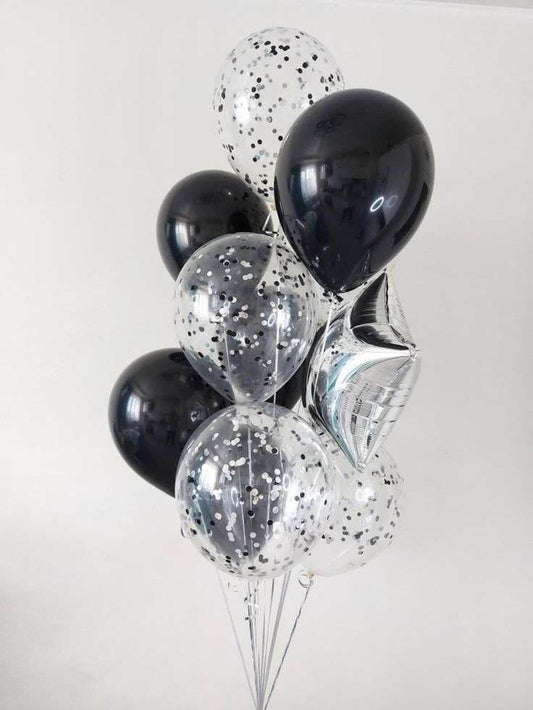 Bouquet of black and clear balloons with silver confetti on a white background
