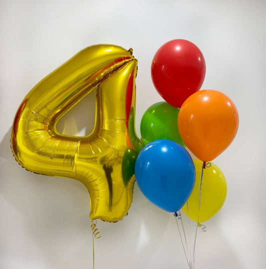 Gold number 4 balloon with colorful helium balloons on a white background